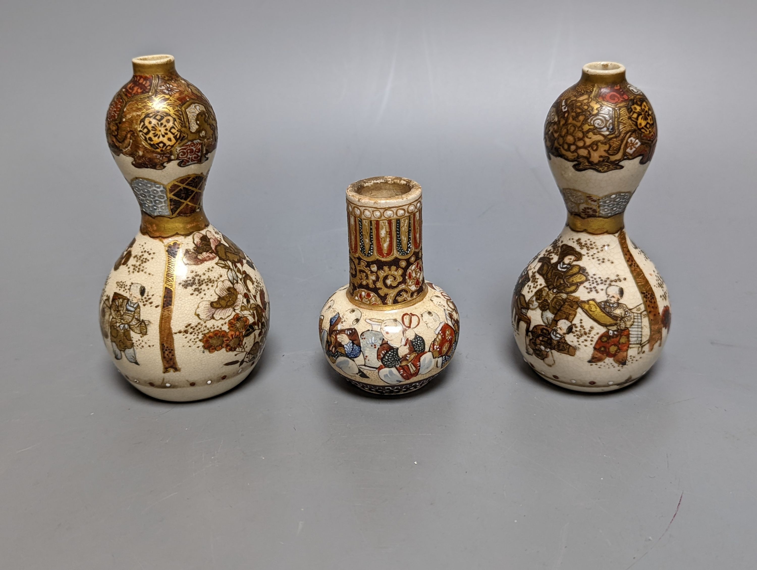 Three Japanese graduated porcelain miniature bowls, a pair of small Satsuma vases and another, pair of vases 12 cms high (6)